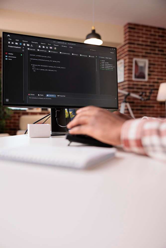 selective-focus-computer-screen-african-american-programmer-working-remote-from-home-developing-software-pc-system-developer-writing-code-personal-computer-typing-algorithm-keyboard